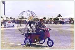  'The Nations first street licensed propeller driven motorcycle. This unique three wheeled 
								vehicle carries two comfortably at 45 miles per hour, even up hills! The Propcycle has been featured in magazines in 17 countries, including 
								Popular Science and Star Magazine in the U.S. It has also been featured on Evening Magazine with Richard Hart and PM Magazine on television 
								Coast to Coast. (photo) Jim Riordans Propcycle at the Watsonville Air Show, 1987' 